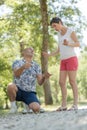 couple disagreeing over game boules in park