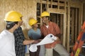 Couple Discussing Construction Plans With Contractors Royalty Free Stock Photo