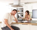 Couple Discussing Personal Finances In Kitchen