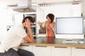 Couple Discussing Personal Finances In Kitchen