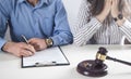 Couple with divorce contract and ring on desk. Divorce