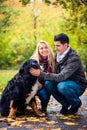 Couple with dog enjoying autumn in nature Royalty Free Stock Photo