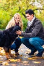 Couple with dog enjoying autumn in nature Royalty Free Stock Photo