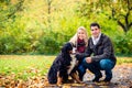 Couple with dog enjoying autumn in nature Royalty Free Stock Photo