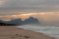Couple and dog running on the beach of Barra da Tijuca in a beautiful dawn with the stone of Gavea in the background - Rio de Jane Royalty Free Stock Photo