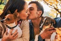 Couple with dogs making selfie while kissing in autumn park Royalty Free Stock Photo