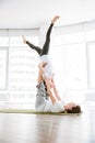 Couple doing acro yoga exercises in studio together Royalty Free Stock Photo