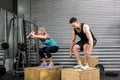 Couple doing box jumps in gym Royalty Free Stock Photo