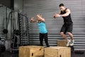 Couple doing box jumps in gym Royalty Free Stock Photo