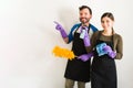 Couple doing chores and pointing at copy space