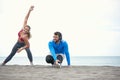 Couple doing exercises on the beach Royalty Free Stock Photo