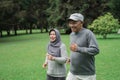 Couple doing exercising by running in the garden Royalty Free Stock Photo