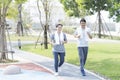 Couple doing exercising by running in the garden. Sporty mature couple styaing fit with sport Royalty Free Stock Photo