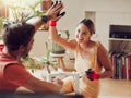 Couple doing high five, well done or good job gesture while painting or remodelling furniture, wooden table for home