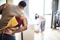 Couple doing a laundry husband surprising wife with bouquet