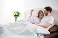 Couple doing online shopping while lying in cozy Royalty Free Stock Photo