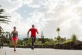 Couple doing running training session outdoor - Sporty people workout sprint exercises Royalty Free Stock Photo
