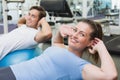 Couple doing sit ups on exercise balls Royalty Free Stock Photo