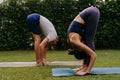 Couple doing yoga in backyard together