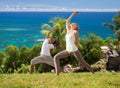 Couple doing yoga over natural background and sea Royalty Free Stock Photo