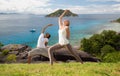 Couple doing yoga over natural background and sea Royalty Free Stock Photo