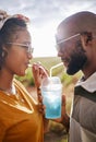 Couple, drink and date with a black woman and man drinking a beverage while outdoor in nature during summer. Dating Royalty Free Stock Photo