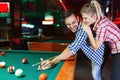 Couple drinking beer playing snooker on date Royalty Free Stock Photo