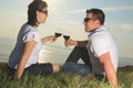 A couple drinking a bottle of red wine outside Royalty Free Stock Photo