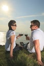 A couple drinking a bottle of red wine outside Royalty Free Stock Photo