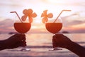 Couple drinking cocktails on the beach at sunset Royalty Free Stock Photo