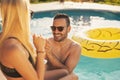 Couple drinking cocktails by the swimming pool Royalty Free Stock Photo