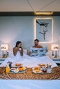 Couple drinking coffee in bed in the morning at an luxury hotel room in Thailand Royalty Free Stock Photo