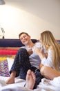 Couple drinking coffee lying in the bed at home Royalty Free Stock Photo