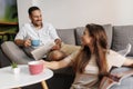 Couple drinking coffee and reading at home Royalty Free Stock Photo