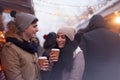 Couple drinking hot beverages at winter