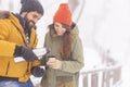 Couple drinking hot tea and enjoying snowy winter day outdoors Royalty Free Stock Photo