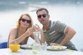 Couple drinking iced tea at breakfast outside