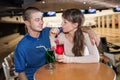 Couple drinking milk cocktail from one glass in bowling Royalty Free Stock Photo