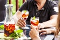 Couple drinking white sangria. White sangria with fruits and berries