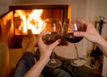 Couple drinking wine in front of a fire Royalty Free Stock Photo