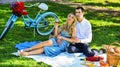 Couple drinking wine sunny day. Attractive Couple Enjoying Romantic Sunset Picnic in Countryside. Cute couple drinking Royalty Free Stock Photo