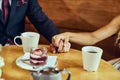 Couple drinks coffee with fruit cakes at a cafe