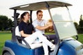 Couple in driving buggy on golf course Royalty Free Stock Photo