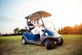 Couple in driving buggy on golf course Royalty Free Stock Photo