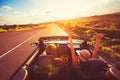 Couple Driving Convertable at Sunset Royalty Free Stock Photo