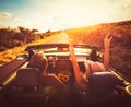 Couple Driving Convertable at Sunset Royalty Free Stock Photo