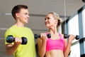 Couple with dumbbells exercising in gym Royalty Free Stock Photo