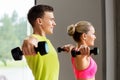 Couple with dumbbells exercising in gym Royalty Free Stock Photo