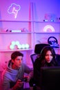 Couple e-sport Caucasian handsome boy and Asian pretty girl support and help each other to playing game online that the best