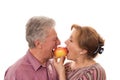 Couple eating an apple on a white background Royalty Free Stock Photo